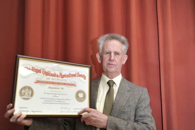 John Turnbull of West Kyloe Farm in Berwick with his certificate for fifty years service presented at Springwood Park Hall in Kelso.
