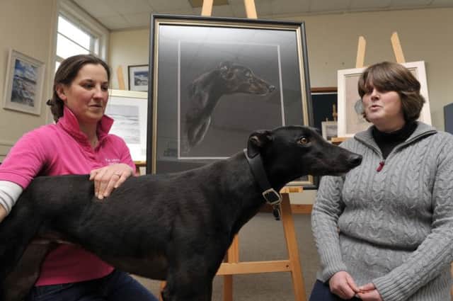 L-r, Denise and Jane of the Vennel Gallery in Kelso. Both are organising the Scottish Borders Arts Fair, a large exhibition at Springwood Park on the weekend of Saturday 22nd March. Pictured here with one of Denise's paintings which is her dog 'Goof' (also in photo).
