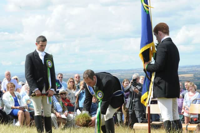 Coldstreamer Colin Leifer cuts a sod of earth from Branxton Hill to take back to Coldstream to lay on the site of the priory