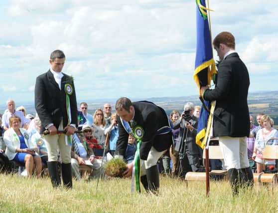 Coldstreamer Colin Leifer cuts a sod of earth from Branxton Hill to take back to Coldstream to lay on the site of the priory