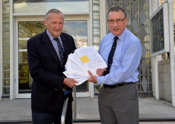 Andrew Farquhar, right, handed in his 7,500-signature strong petition calling on Scottish Borders Council to reinstate green waste collections to Councillor Alec Nicol, chairman of the council's petitions committee