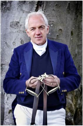 Olympic rider Ian Stark holds a pair of stirrups used by The Duke of Wellington at the Battle of Waterloo in 1815.