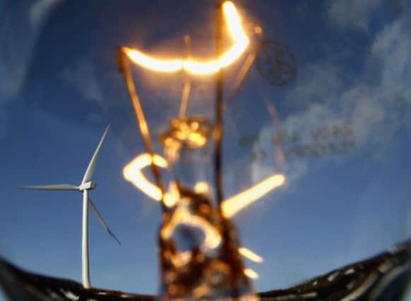 Wind turbines are seen through a lightbulb at the Braes of Doune wind farm in Stirling. Picture: Getty
