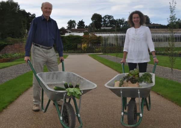 Volunteers Jake Coltman and Barbara Brzyk with some of the produce from the Wilton Lodge Park walled garden in Hawick, which is now open to the public. Picture SBC