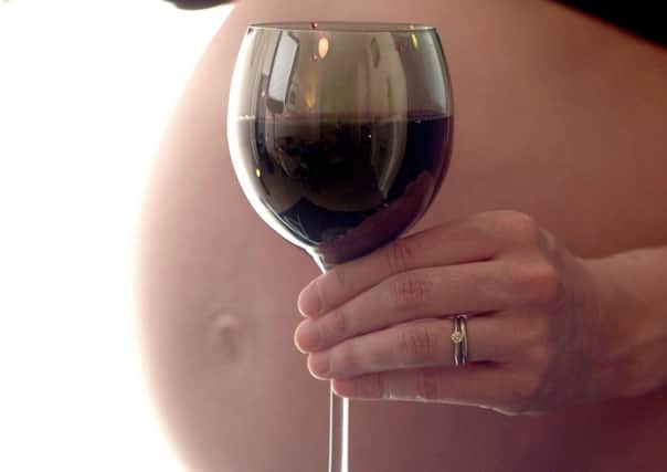 Embargoed to 2330 Monday July 6 File photo dated 28/01/15 of an eight month pregnant woman holding a glass of wine. Alcohol use during pregnancy is "prevalent and socially pervasive" in the UK and Ireland, health experts have warned after carrying out a large scale study. PRESS ASSOCIATION Photo. Issue date: Monday July 6, 2015. Women across all socio-demographic groups were likely to drink - but those who smoked were up to 50% more likely to consume alcohol while pregnant, research led by the University of Cambridge found. Researchers described the widespread consumption of even low levels of alcohol during pregnancy as a "significant public health concern". See PA story HEALTH Pregnancy. Photo credit should read: Anthony Devlin/PA Wire