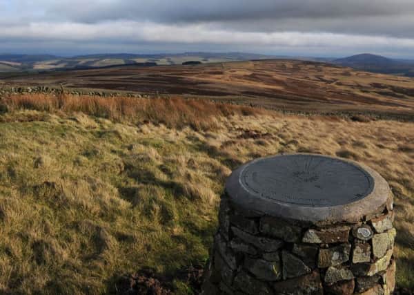 Cairn in near Longformacus topped with a millennium compass looking east towards Cockburn Law. The Compass carries the message 'respect for the earth, peace for its people'