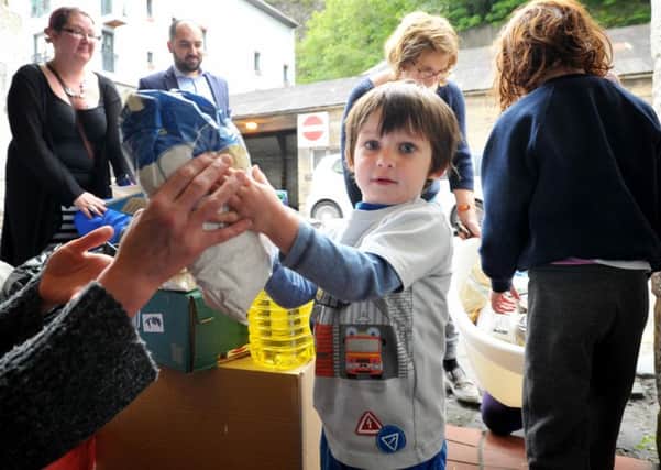 ***JP 60-day licence***

Members of the Edinburgh branch of CalAid, an established humanitarian aid organisation, have set up a drop-off point at Studio 24, Calton Road, Edinburgh, where people can drop-off their aid donations for refugees in Calais and Europe. Pictured is Tomas Mallon, aged 2, who arrived with his family from West Pilton, Edinburgh, to donate some camping items and food.

3rd September 2015. Picture by JANE BARLOW

© Jane Barlow 2015 {all rights reserved}
janebarlowphotography@gmail.com
m: 07870 152324