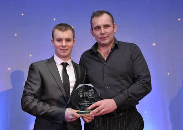 GB Technologies managing director Gordon Brown presents Stuart Easton with his award in 2014