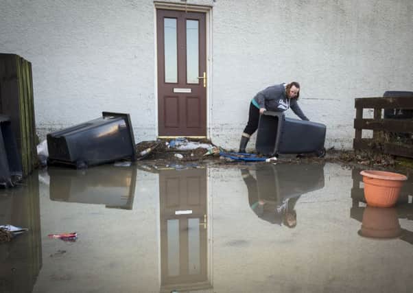 A woman clears flood debris in Hawick. Picture: Danny Lawson/PA Wire