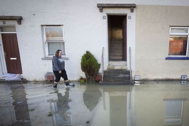 A woman walks through floodwater in Hawick after the River Teviot burst its banks. Picture: Danny Lawson/PA Wire