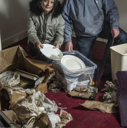 Sheena and John Gillespie cleaning up after the floods saw their rented home on Commercial Road damaged with around 2 feet of water.