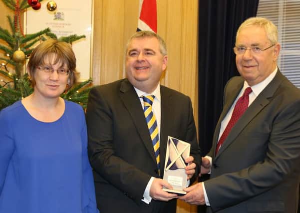 David Parker, with wife Ruth, accepts his 2015 Scottish Local Politician of the Year award from council convener Graham Garvie.
