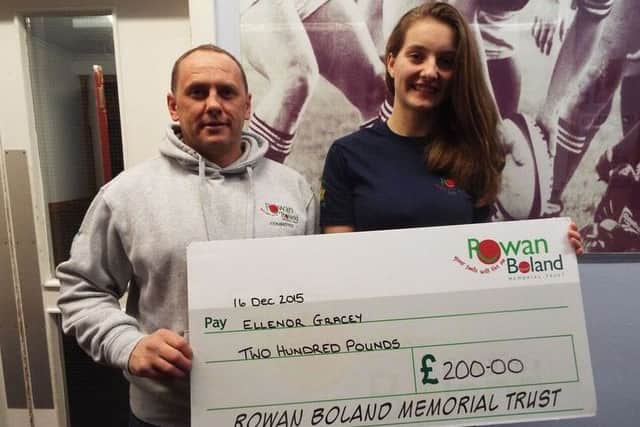 Swinton swimmer Ellenor Gracey receives a cheque for Â£200 from David Boland on behalf of the Rowan Boland Memorial Trust.