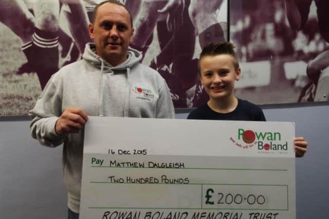 David Boland presents a cheque to Matthew Dalgleish