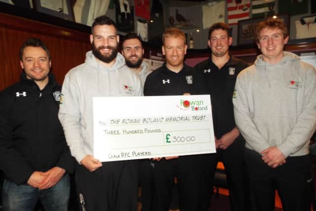 Gala RFC players, in black shirts, Andy McLean, Dean Keddie and Craig Borthwick hand over the cheque to team-mates and Rowan Boland Trust committee members Al Emond, Kris Mein and Euan Dods (grey jumpers).