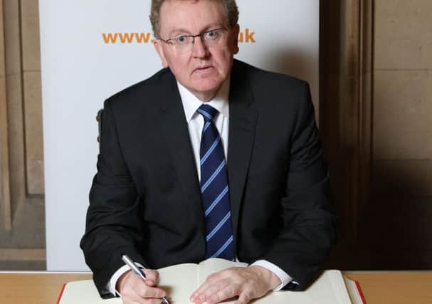 David Mundell MP who has honoured Holocaust Memorial Day, by signing the book of commitment by the Holocaust Educational Trust.