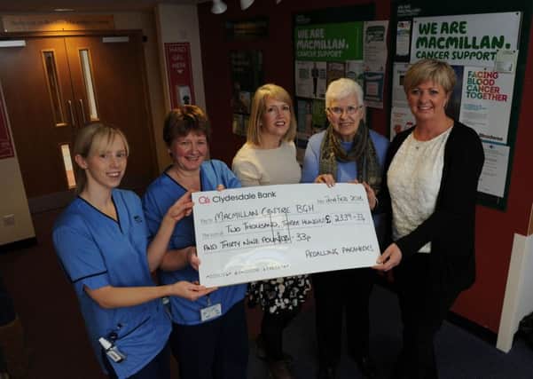 Nurses Claire Hannah, Valerie Gibson and CISS manager Claire Ervine recieving the cheque at the Borders Macmillan centre from Mary Jappy and daughter Sandra Allen