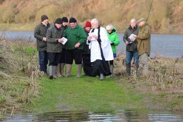 Rev Rob Kelsey blesses the Tweed at Pedwell landing Norham, to mark the opening of the salmon fishing season.