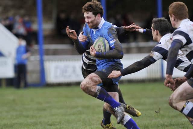 Robbie Shirra-Gibb escapes the clutches of the Heriot's defence