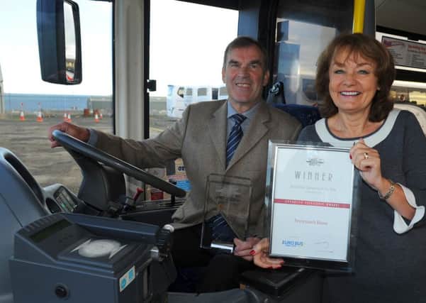 Richard and Linda Perryman with one of the small bus operator awards they won, will work to a different timetable after seling the business