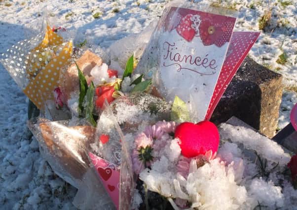 Floral tributes left beside the A698 for Kirsty Parker