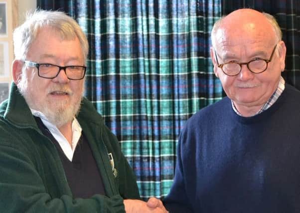 Murray Watson presents a Hawick Rugby Memories Club tie to Jim Renwick, who entertained a record crowd of more than 40 people, including guests from Galashiels and Selkirk, at this months gathering.