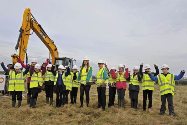 Sod cutting at the new site of Kelso High School on Angraflat Road, Kelso. The sod-cutting was carried out jointly by Kelso Highs current head boy Charlie Bisset and head girl Katie Best at the site of the new school. Work is set to begin on the new Â£22.5million Kelso High School, which is set ot completed by autumn 2017.
