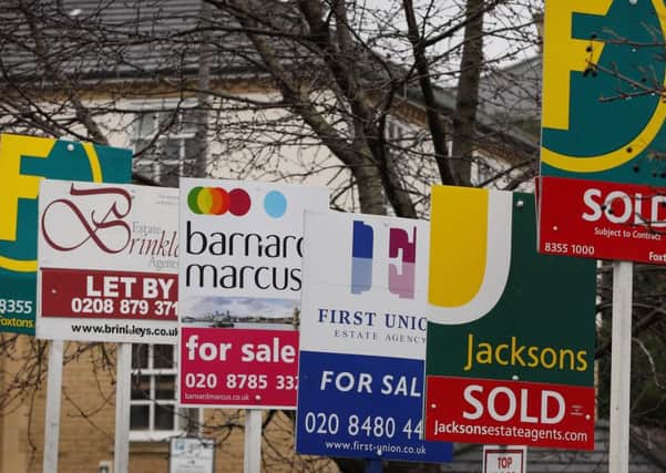 LONDON, ENGLAND - MARCH 07:  Sale and rent signs are displayed by estate agents on a block of flats near Wandsworth on March 7, 2012 in London.  (Photo by Peter Macdiarmid/Getty Images)