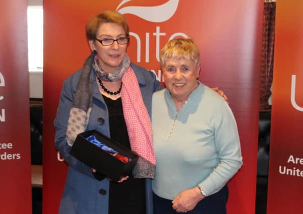 Perennial campaigner Muriel Johnstone is presented with glassware by deputy regional secretary Mary Alexander at Unite the Unions Borders area activists meeting in Galashiels.