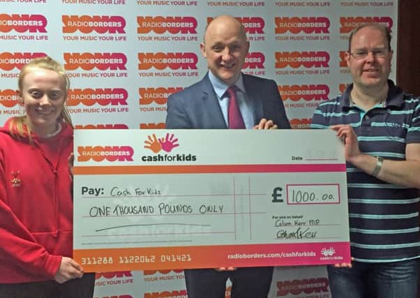 Jenni Heatlie and Calum Kerr hand the cheque over to Keith Clarkson of Radio Borders