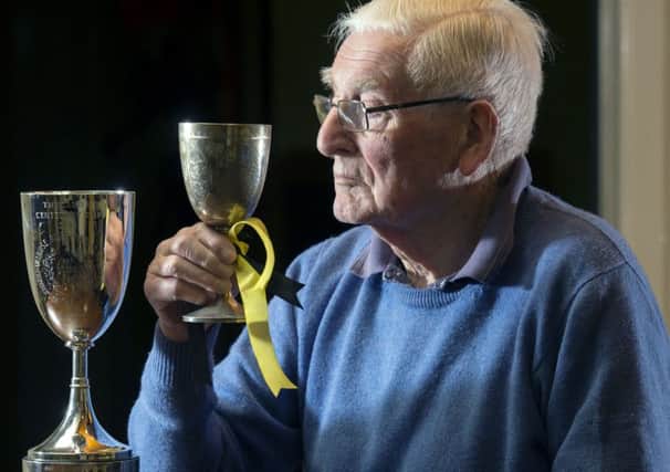 Former player, referee and Melrose president Jack Dunn holds the original Ladies Cup. Picture: Ian Rutherford