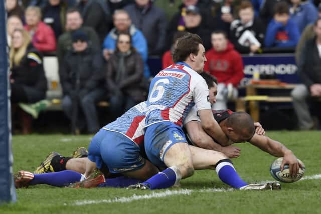 Edinburgh's Will Helu scores a try despite being tackled by tackled by Jed's Ian Chisholm and Gregor Young during the final.  Picture: Ian Rutherford