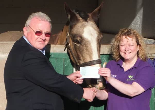 Kelso Rotary Club president John Lafferty presents a cheque to Nicky Glendinning and Mr Bling, of Stable Life at Dryden, Ashkirk.