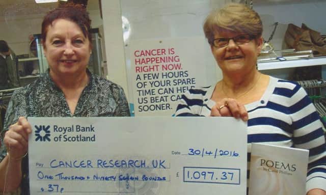 Carol Phillips, right, handing over a cheque for Â£1,097 to Barbara Bennett, manager of Cancer Research UKs shop in High Street, Galashiels.