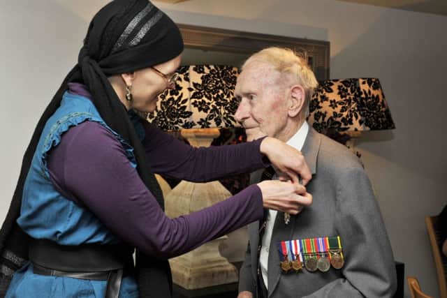 John (Jackie) Webster aged 96 of Galashiels, KOSB veteran, is presented with the French Legion of Honour by the French vice-consul Emiline Javierre (pictured) at a ceremony in Quins Restaurant in Gala.