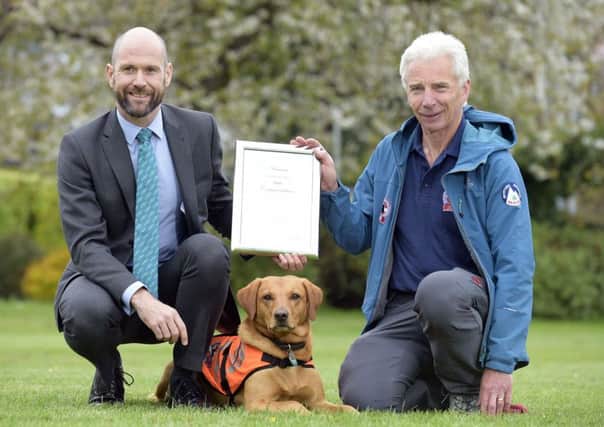 PIC Â© Sandy Young 07970 268944
Scottish search dog honoured.
Rauour (3 year old Labrador) receives PDSA commendation for devotion to duty.
Pictured L-R and PDSA Vet, John Faulkner, Rauour and handler John Romanes 

A three-year-old Labrador from Selkirk is being honoured by vet charity PDSA after successfully finding a critically injured missing woman in blizzard conditions.

Auburn-haired Search and Rescue dog Rauour  which means red in Icelandic  was presented with his PDSA Commendation by the charitys Vet Surgeon, John Faulkner, at the Tweed Valley Mountain Rescue Teams Melrose base this week.  


www.scottishphotographer.com
sandyyoungphotography.wordpress.com
sj.young@virgin.net
07970 268 944