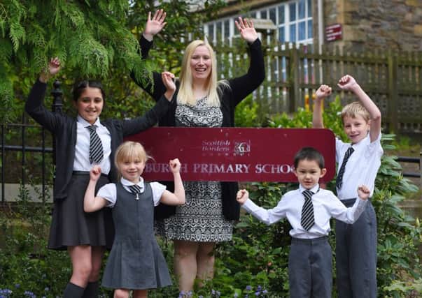 Burgh Primary School have been given a good report. L-r, Norah Campbell (p6), Chloe Millar (p1), Ms Jenny Grant (Headteacher), Daniel Ho (p1) and Jaysen Young (p6).