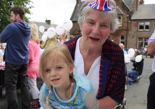 LLAGs celebrations for the Queens 90th birthday.
Newcastleton street party
fancy dress winner Jade Jackson, cutting the celebration cake with Alice Forster, LLAGs Chairperson,