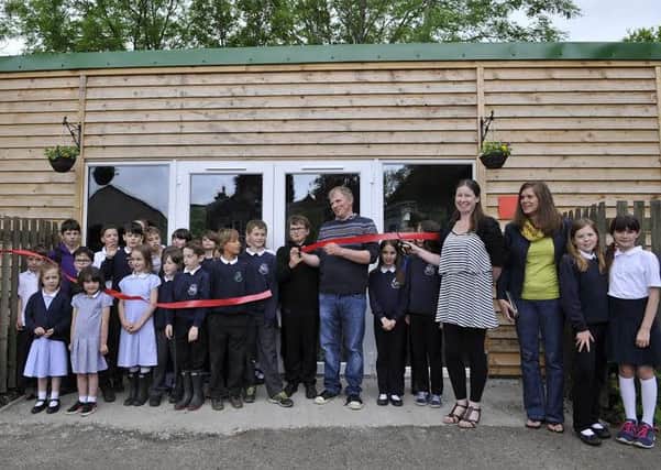 Gary and son Daniel Fleming cut the ribbon to officially open the new outdoor learning centre at Heriot Primary School.