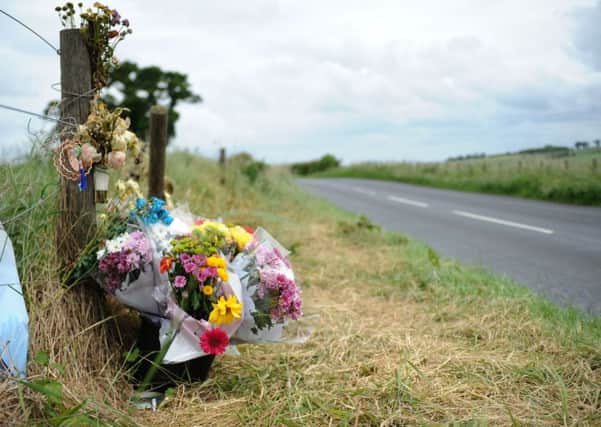 Floral tributes beside the B6350 near Redden Farm following a fatal crash
