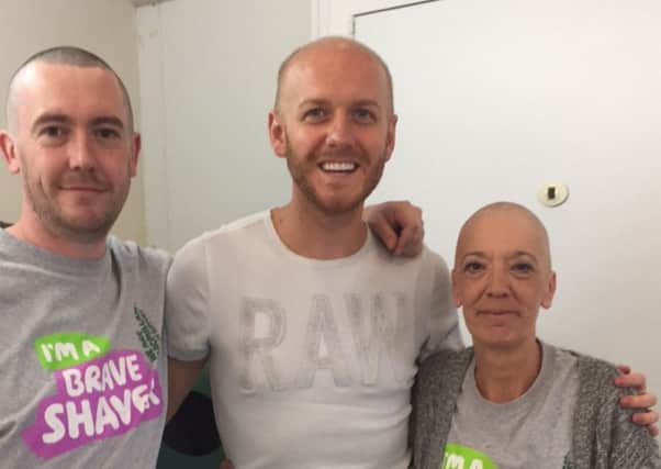 Fiona Duncan, of Silverbuthall, Hawick, and son Jamie, of Edinburgh after having their heads shaved by Kev Sykes for charity.