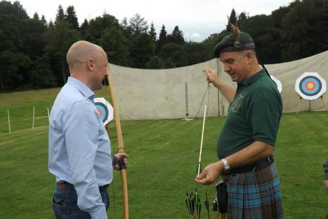 Borders MP Calum Kerr gets some tuition in the longbow from Ettrick Forest Archers chairman Doug Anderson.