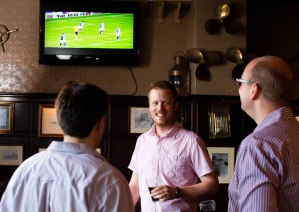 Pub showing football on TV. Image for use with TV Licencing campaign.