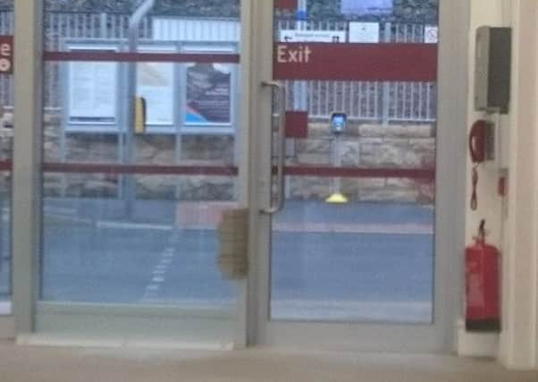 Gareth Cuthbert sent this photo of what appears to be a repair by parcel tape at the train exit door of the Interchange building.