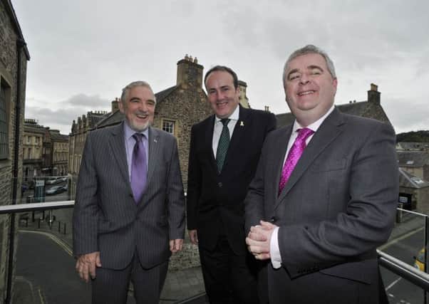 MSP Paul Wheelhouse, centre, in Hawick with Scottish Borders Council leader David Parker, right, and fellow executive member Stuart Bell.
