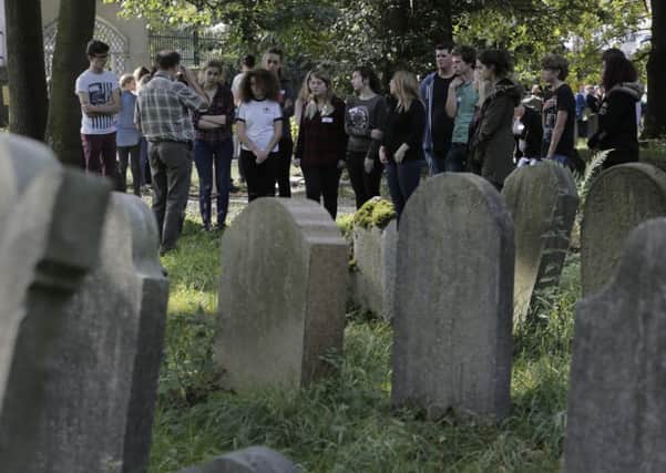 Pupils from all over Scotland gather in the old Jewish cemetery in Oswiecim