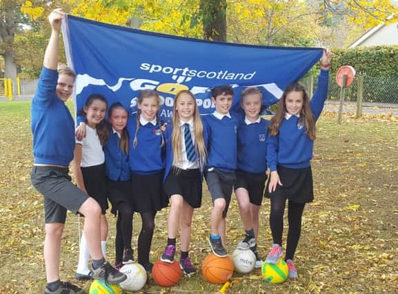 Representatives of Live Borders, sportscotland and Scottish Borders Council join pupils and staff from Priorsford to celebrate the award
