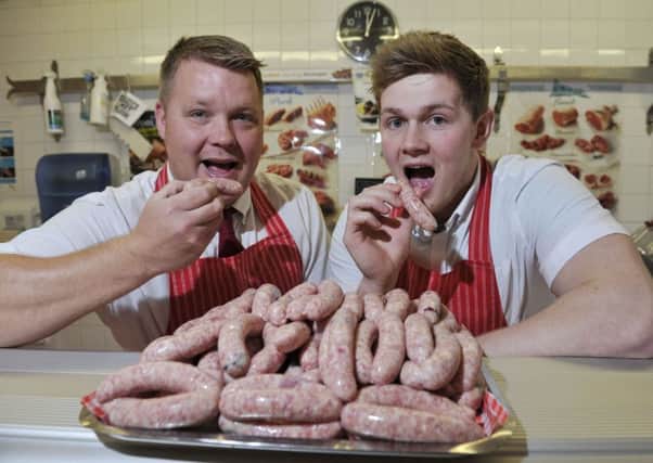 Grant Archibald, left, and Sean Fairbairn of Hutton's Butchers, Hawick, with sausages with blueberries and raspberries in, the colours of Hawick Royal Albert's home and away strips.