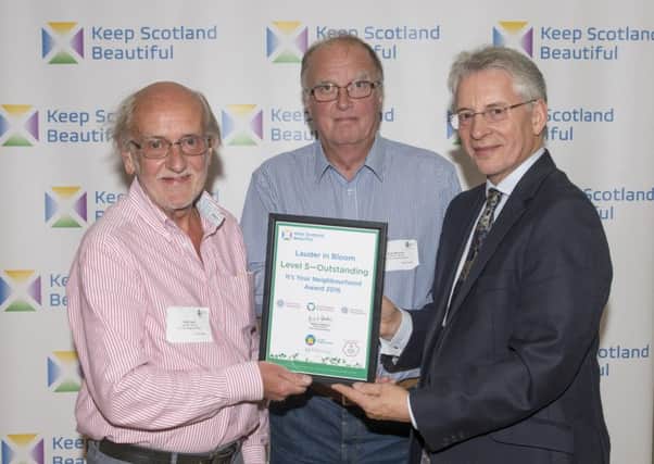 Lauder in Bloom pick up Outstanding Achievement award from Keep Scotland Beatiful. Volunteers Robin Hugh (left), Hugh McKinven (centre) and Keep Scotland Beautiful chief executive Derek Robertson.