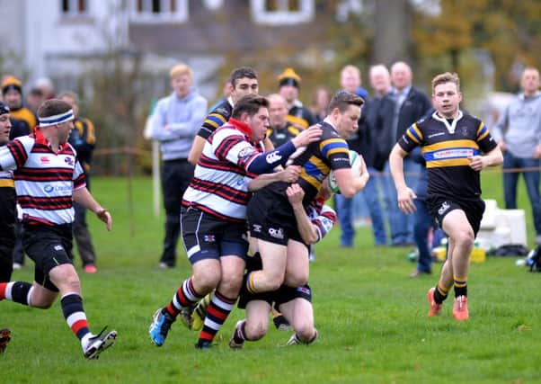 Hawick Harlequins, in the black strips, try to make a breakthrough against Murrayfield Wanderers (picture by Alwyn Johnston)